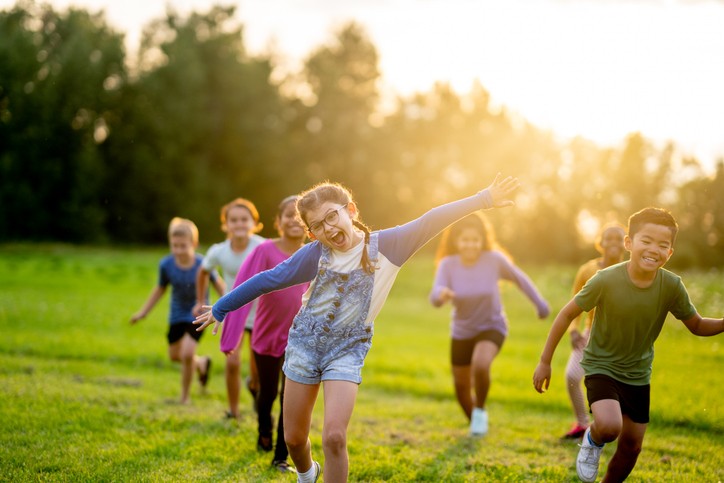 kids running across field in summer